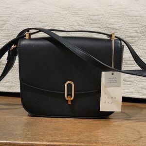 A New Day Black Crossbody Bag with Gold Hardware and Structured Design